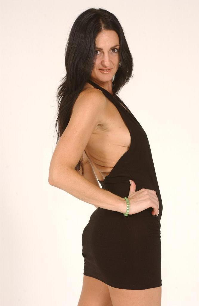 18P Brunette MILF Lake Russell sets her natural tits free of a short dress