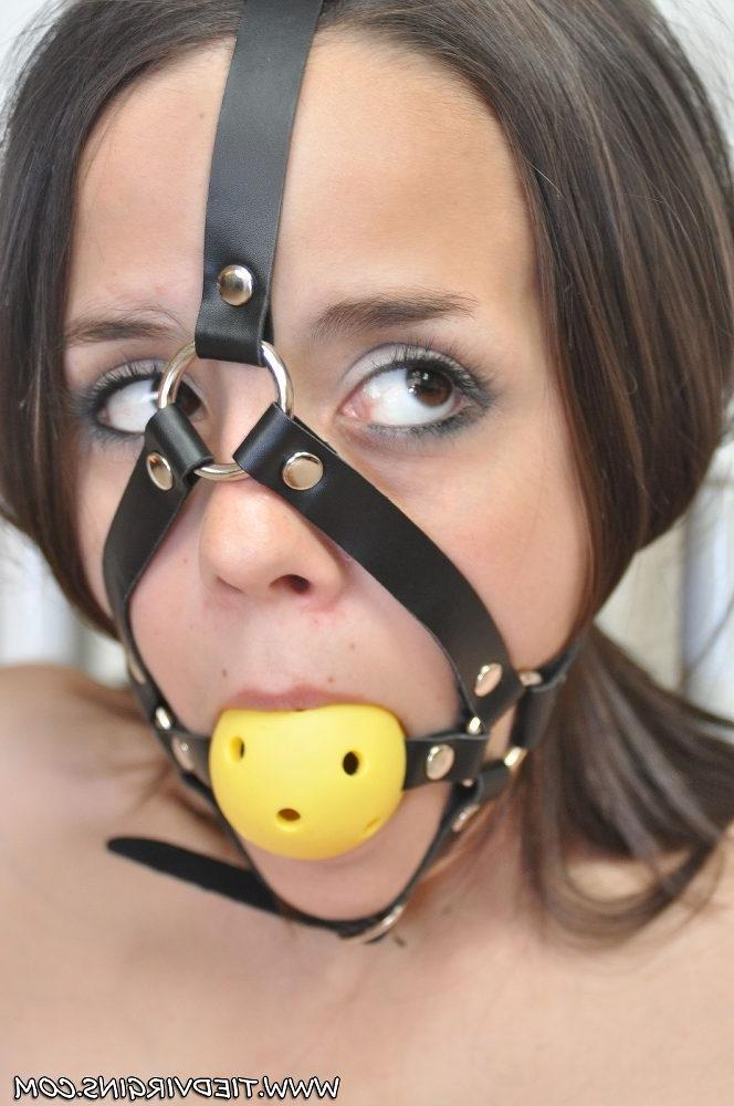 12P Topless girl is tied to a railing with a ball gag firmly affixed in her mouth