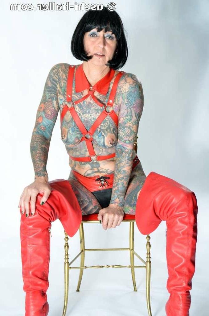 16P Solo girl Tattoogirl Cleo models a bondage harness in thigh-high boots