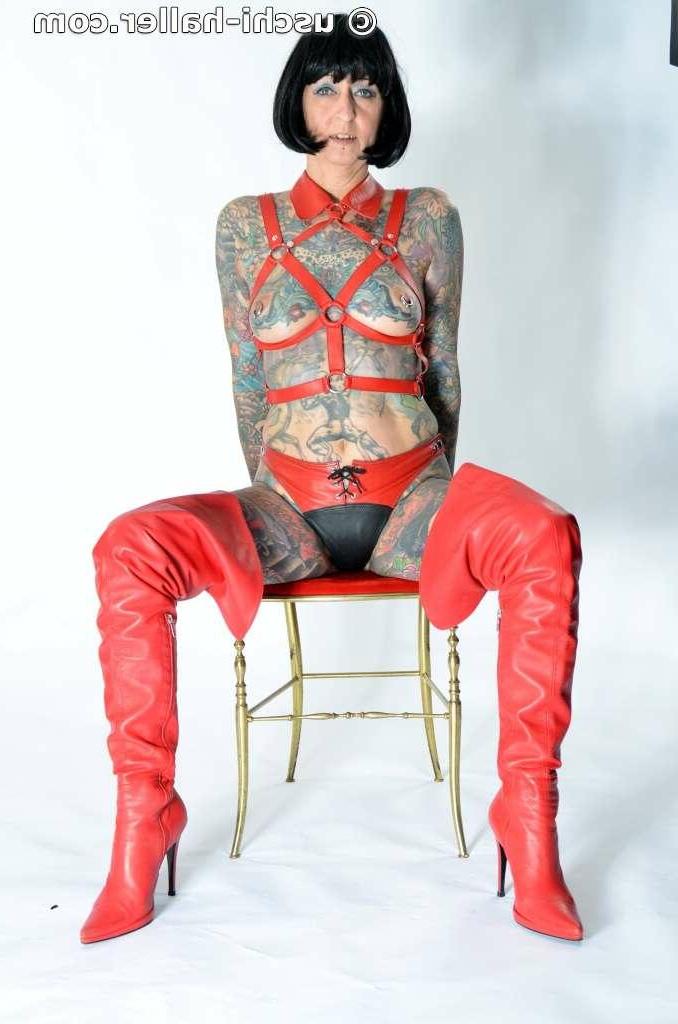 16P Solo girl Tattoogirl Cleo models a bondage harness in thigh-high boots