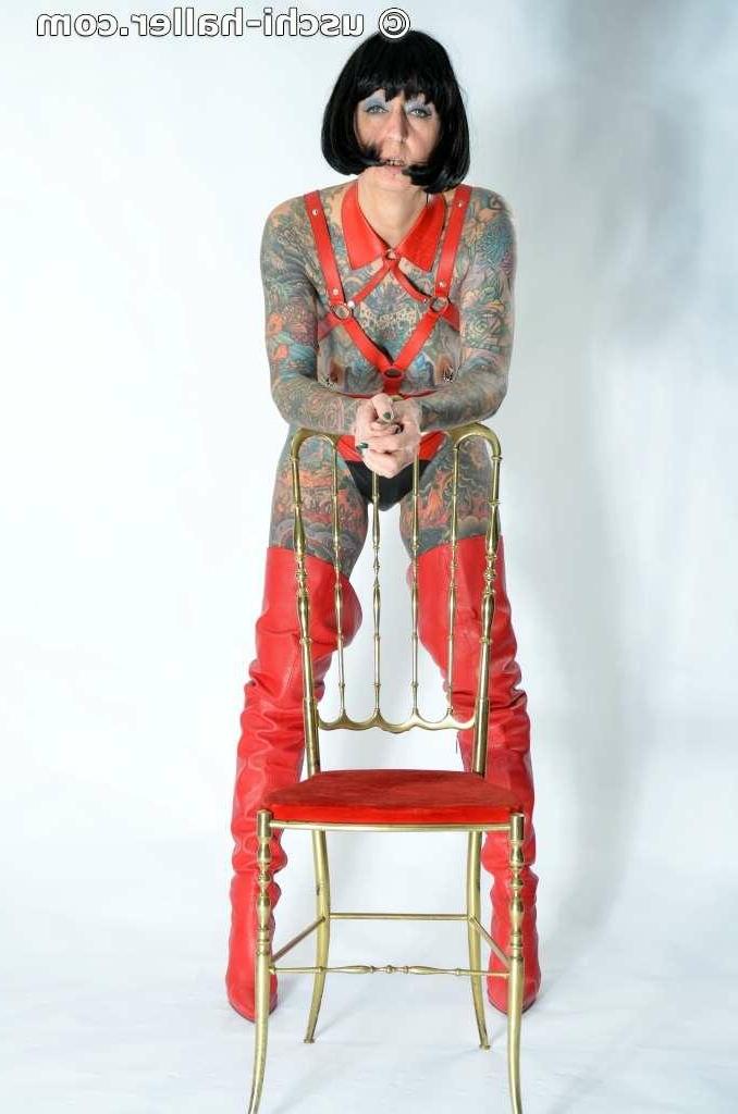 16P Solo girl Tattoogirl Cleo models a bondage harness in thigh-high boots