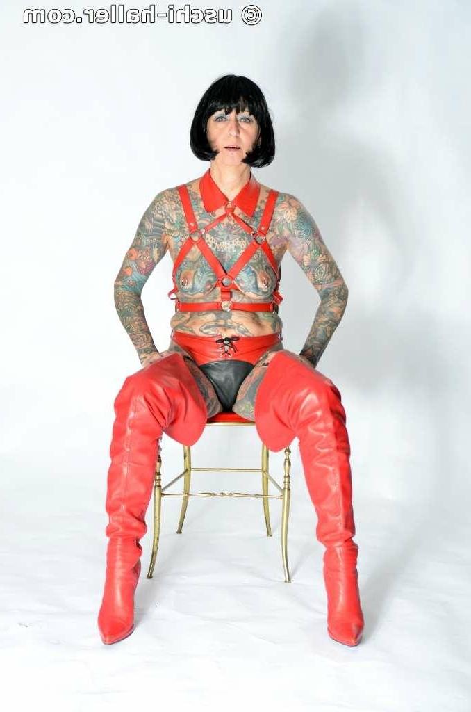 16P Solo girl Tattoogirl Cleo models a bondage harness in thigh-high boots