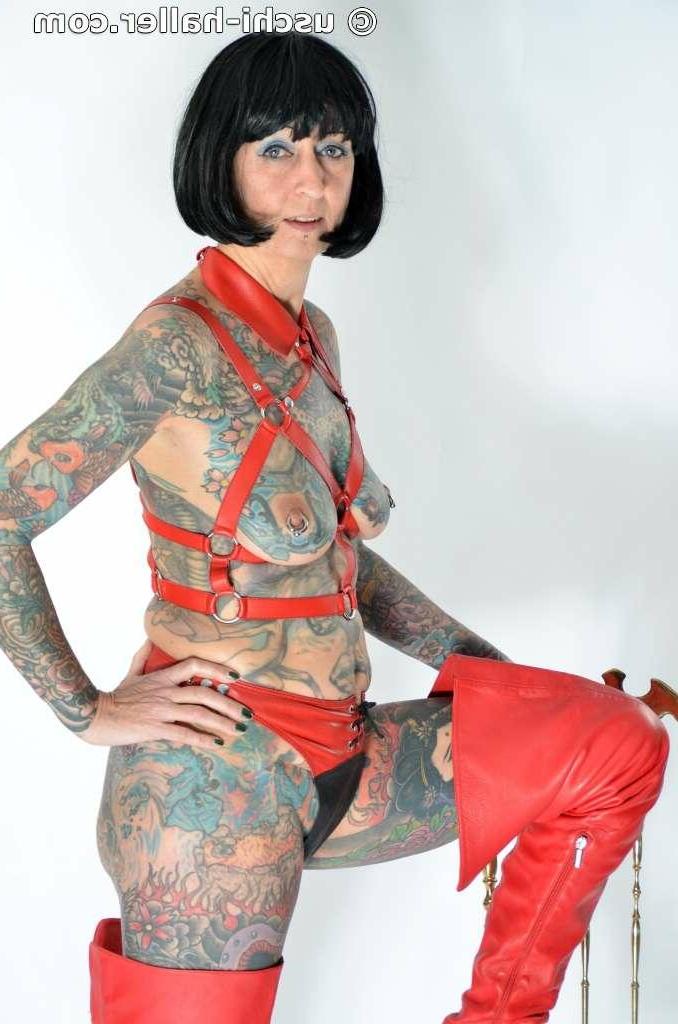 16P Solo girl Tattoogirl Cleo models a bondage harness in thigh-high boots