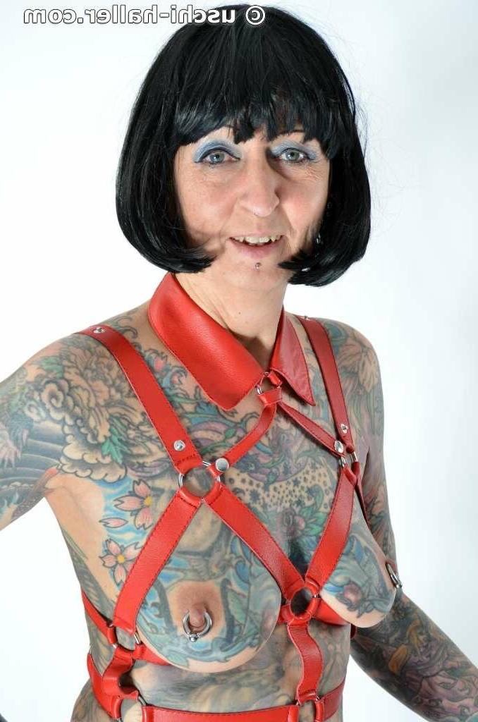 16P Solo girl Tattoogirl Cleo models a bondage harness in thigh-high boots