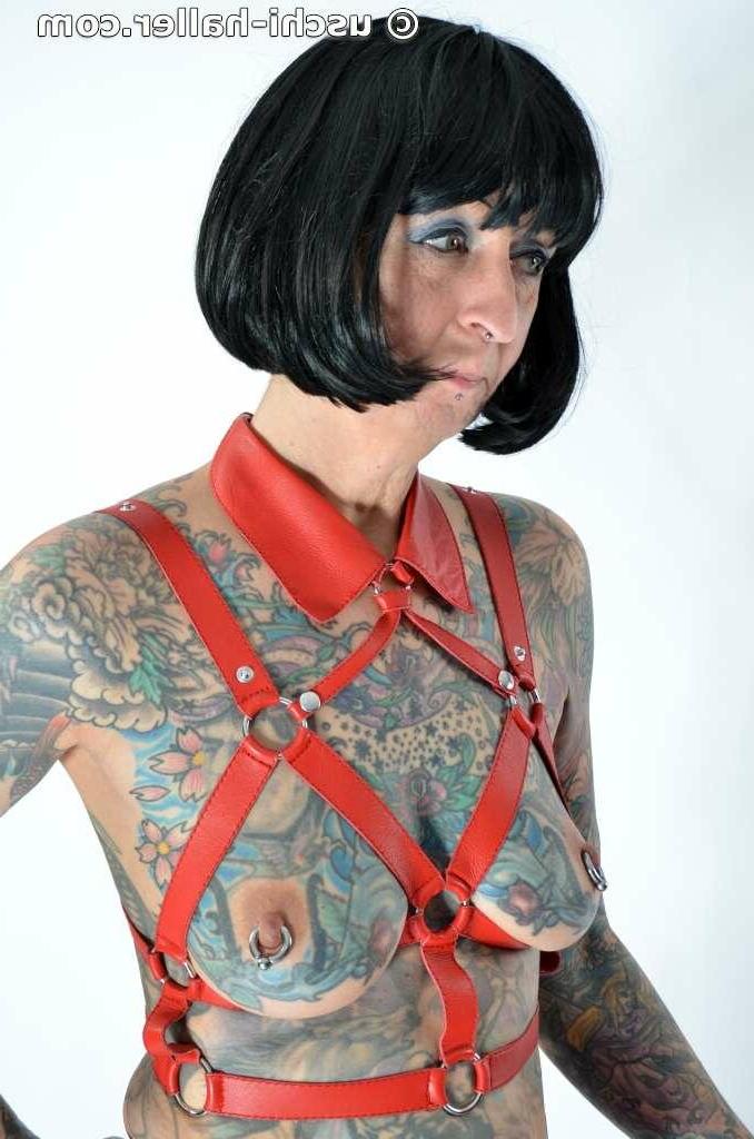 16P Solo girl Tattoogirl Cleo models a bondage harness in thigh-high boots