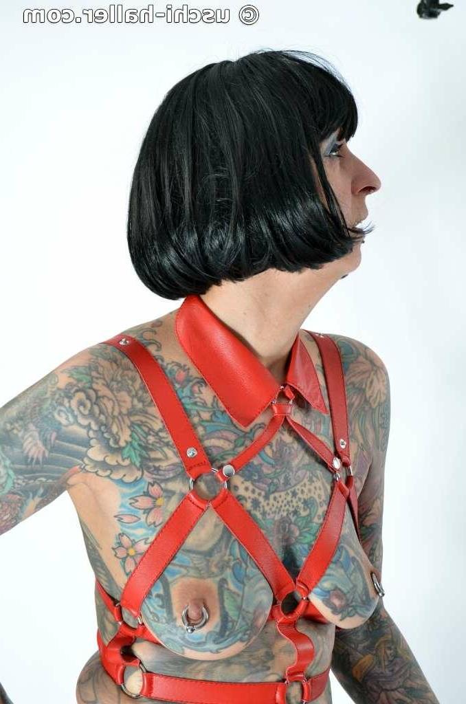 16P Solo girl Tattoogirl Cleo models a bondage harness in thigh-high boots