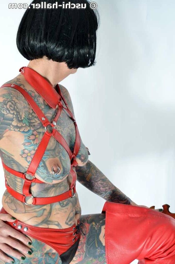 16P Solo girl Tattoogirl Cleo models a bondage harness in thigh-high boots
