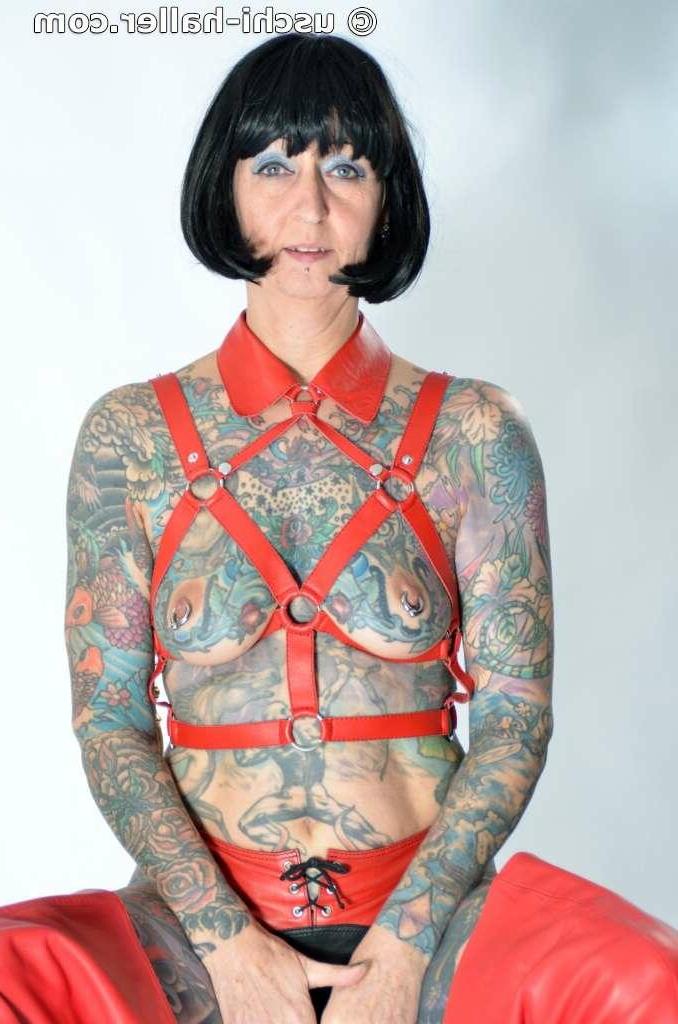 16P Solo girl Tattoogirl Cleo models a bondage harness in thigh-high boots