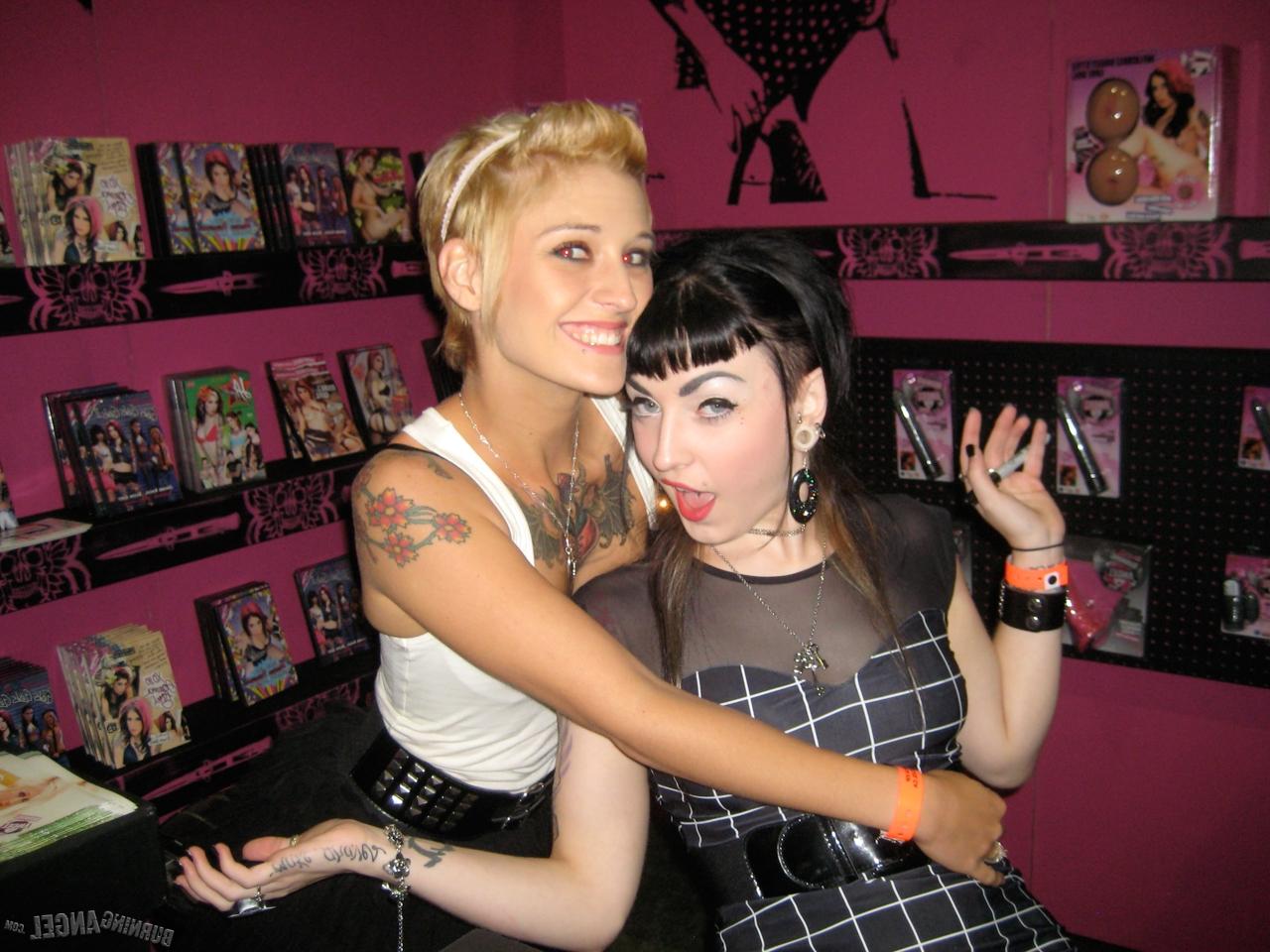 15P Clothed females with tattoos flash their butts while at a party