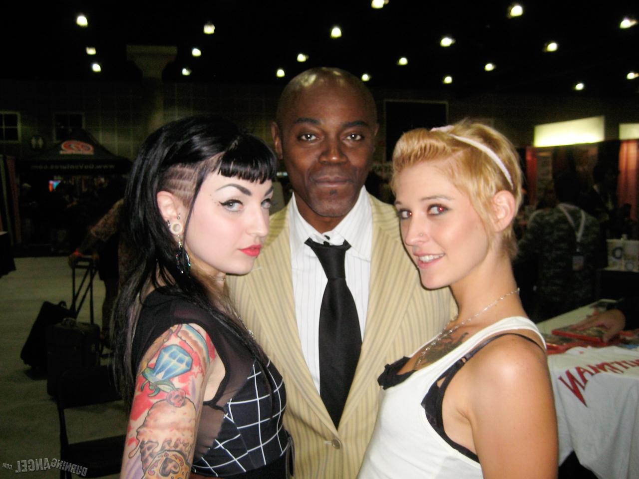 15P Clothed females with tattoos flash their butts while at a party