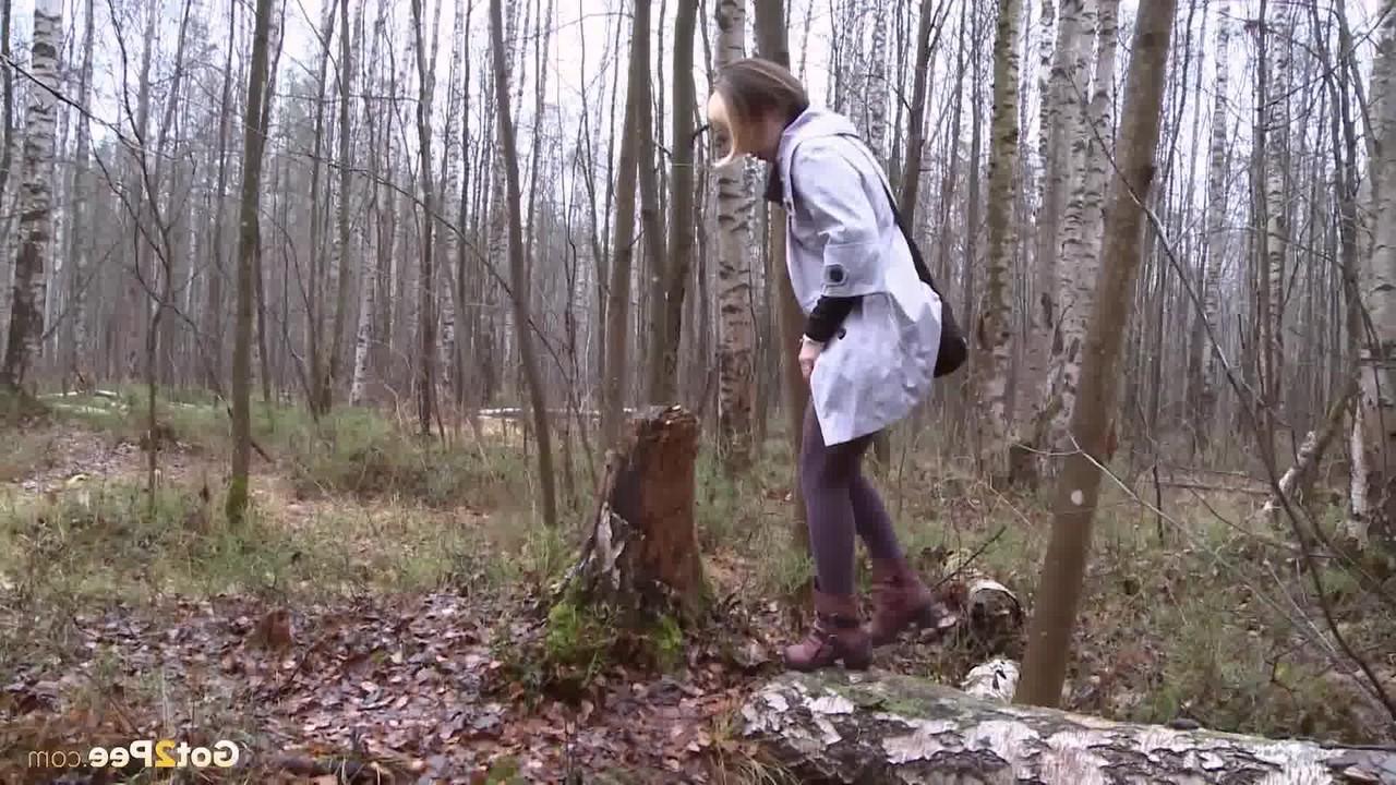 15P Clothed girl Anya pulls down tights on a log to pee into a stream in the woods