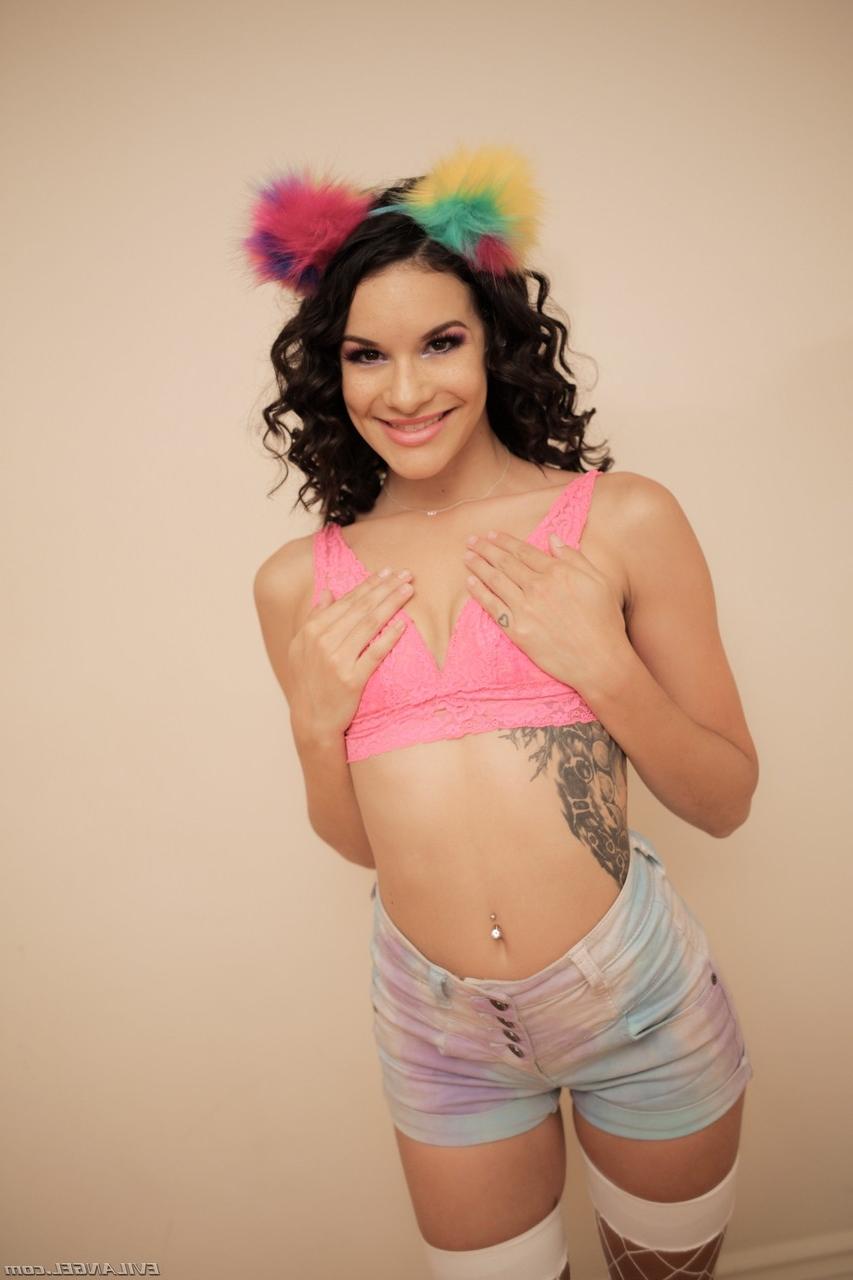 15P Cute brunette Eden Sin displays her flexibility in fishnet stockings and heels