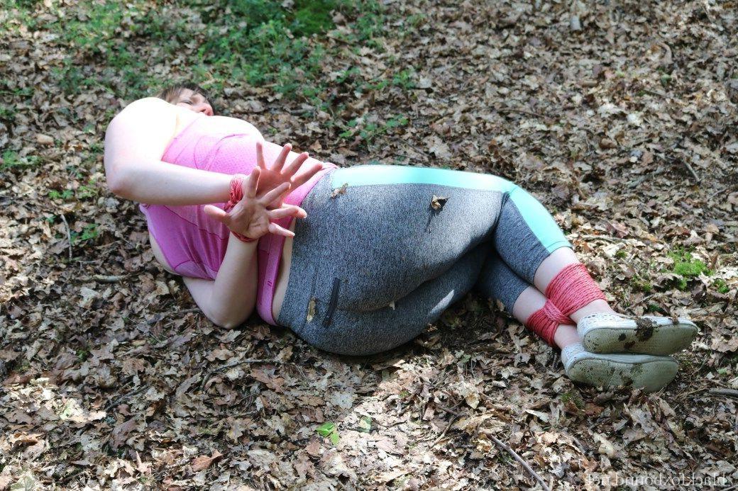 16P Caucasian girl is hogtied and gagged in her clothes upon dried leaves