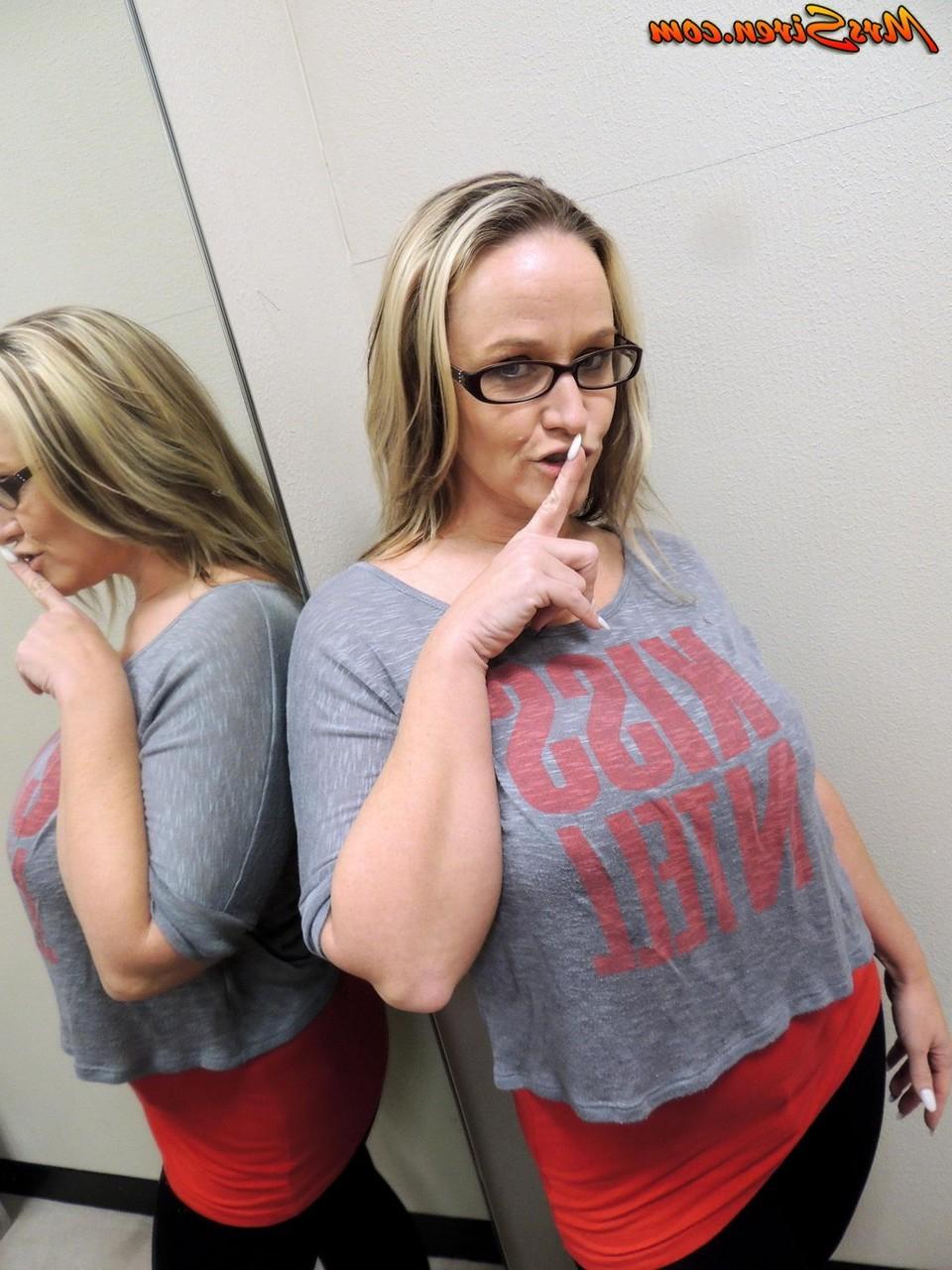 10P Dee Siren pulls down her pants while looking in a dressing room mirror