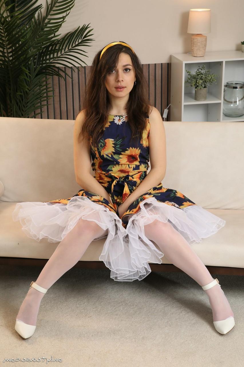 16P Pretty brunette Gia takes off a dress to go topless in white nylons