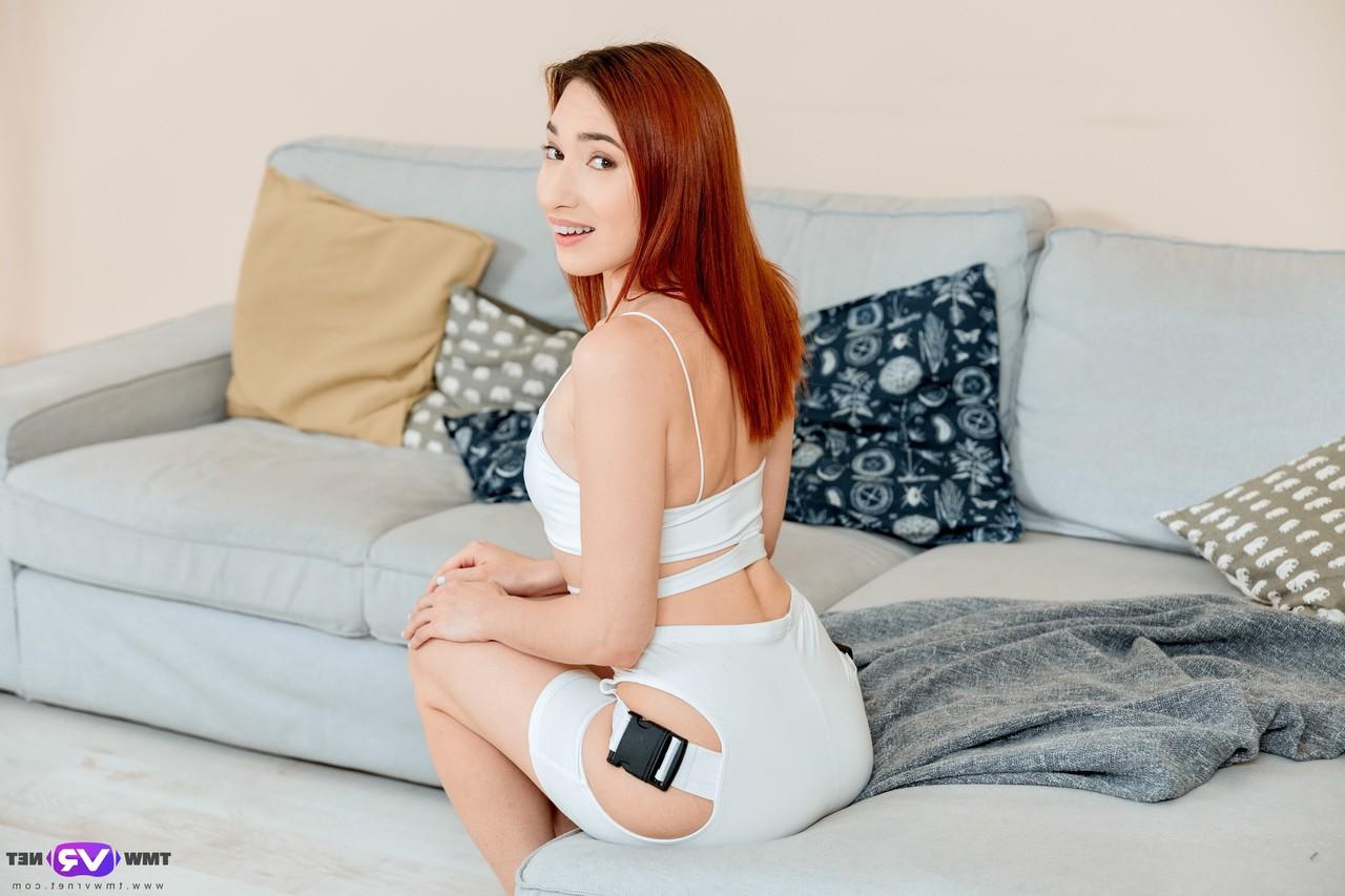20P Sexy redhead Angie A strips and fingers her horny pussy on the couch
