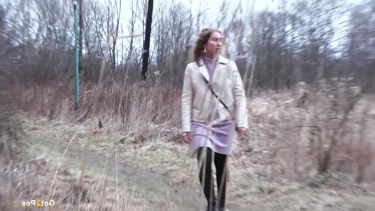 15P Rita, une petite fille prise, s'accroupit pour pisser derrière un immeuble à la campagne.