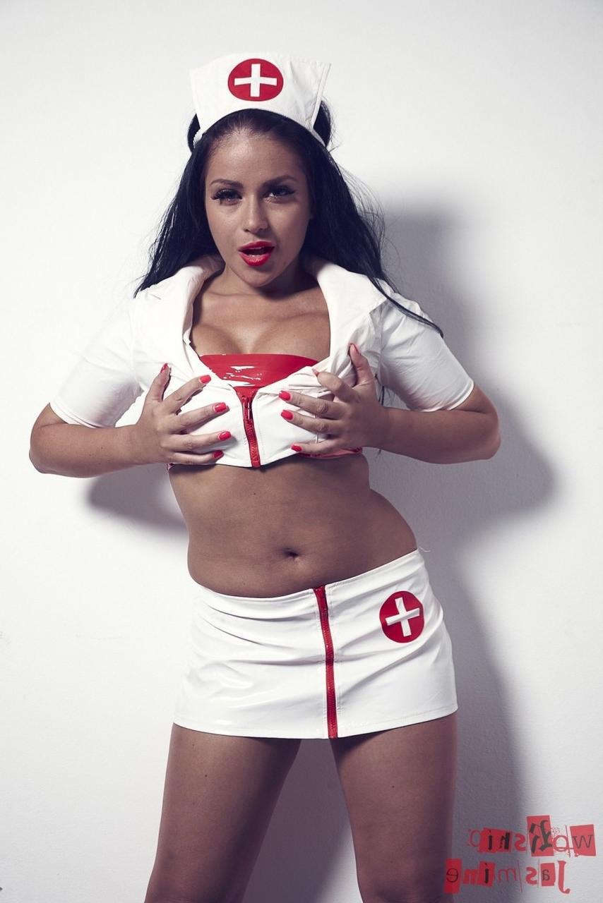 12P L'infirmière brune et sexy Jasmine Jones enlève son uniforme tout en portant une tenue en latex.
