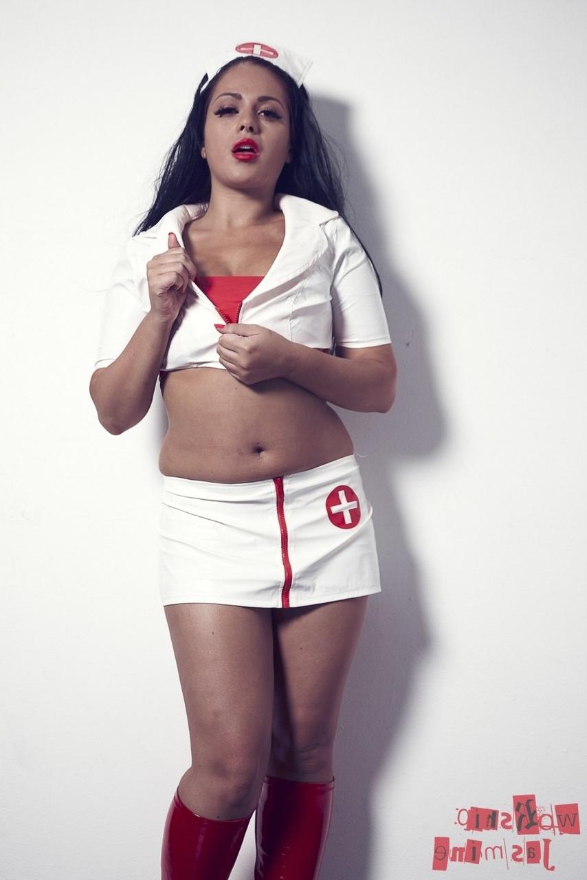 12P L'infirmière brune et sexy Jasmine Jones enlève son uniforme tout en portant une tenue en latex.