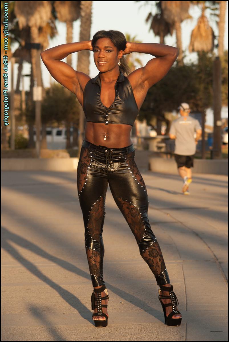 15P Ebony bodybuilder Jaquita Person Taylor models leather clothing on a boardwalk