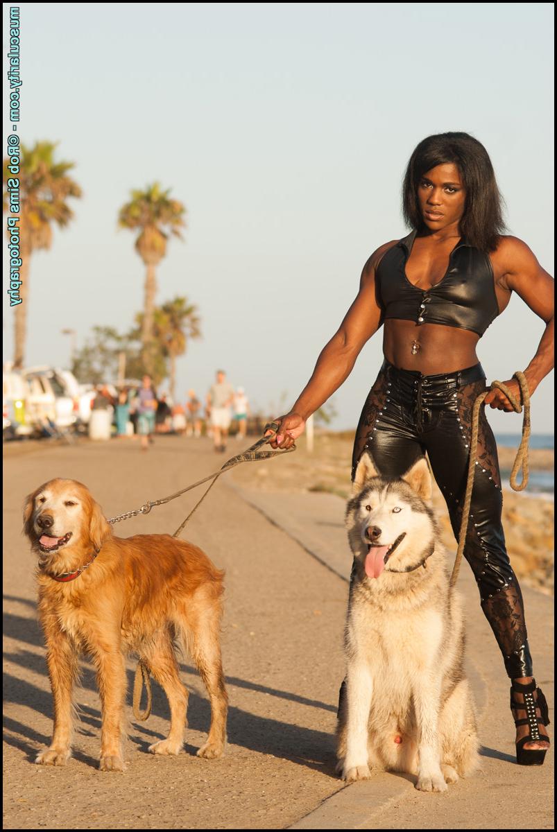 15P Ebony bodybuilder Jaquita Person Taylor models leather clothing on a boardwalk