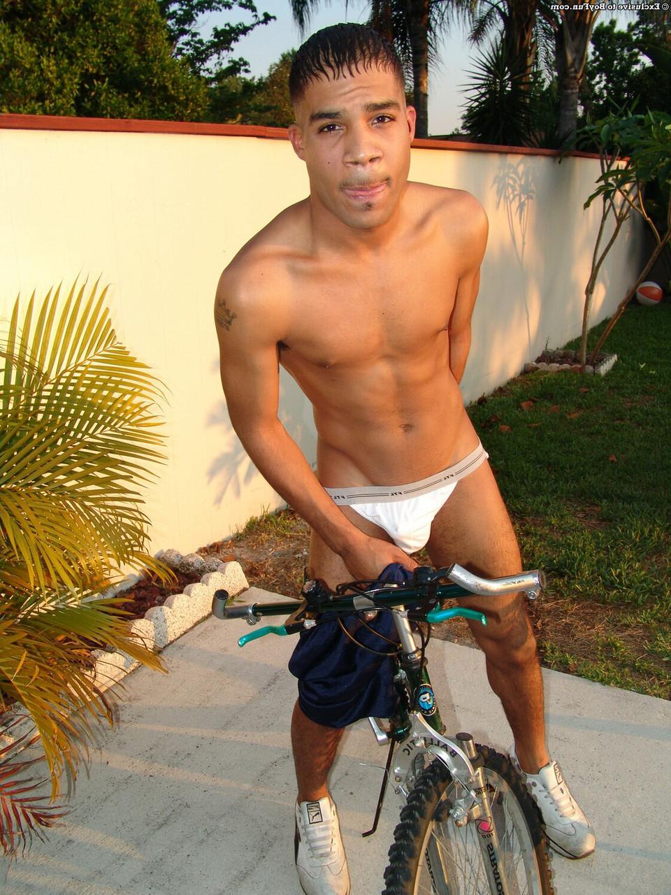 20P Gay ebony bicycler strips in the sunshine & shows his huge uncut dick