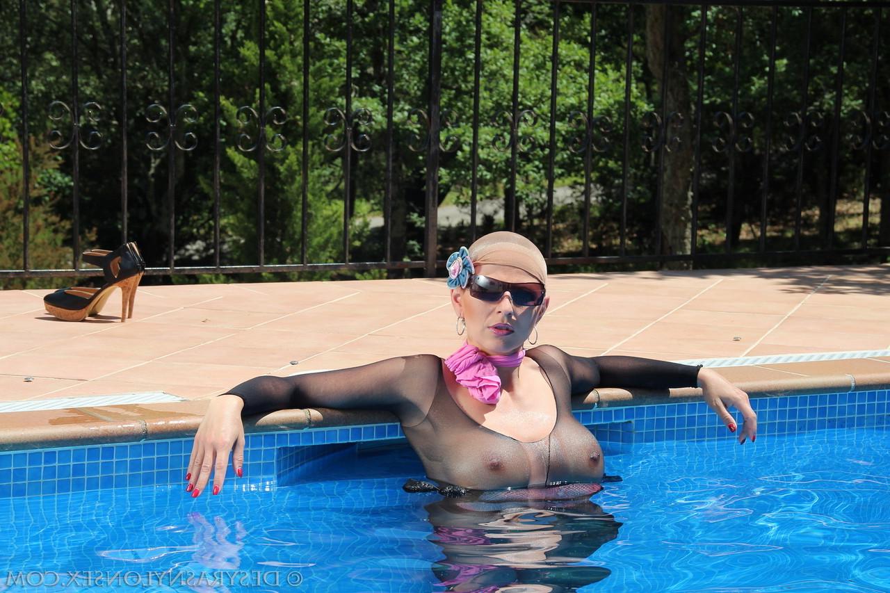 15P German MILF Desyra Noir poses in her sexy sheer lingerie & heels at the pool