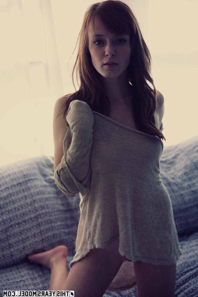 15P Sexy natural redhead Ellie Jane gets completely naked on a chesterfield