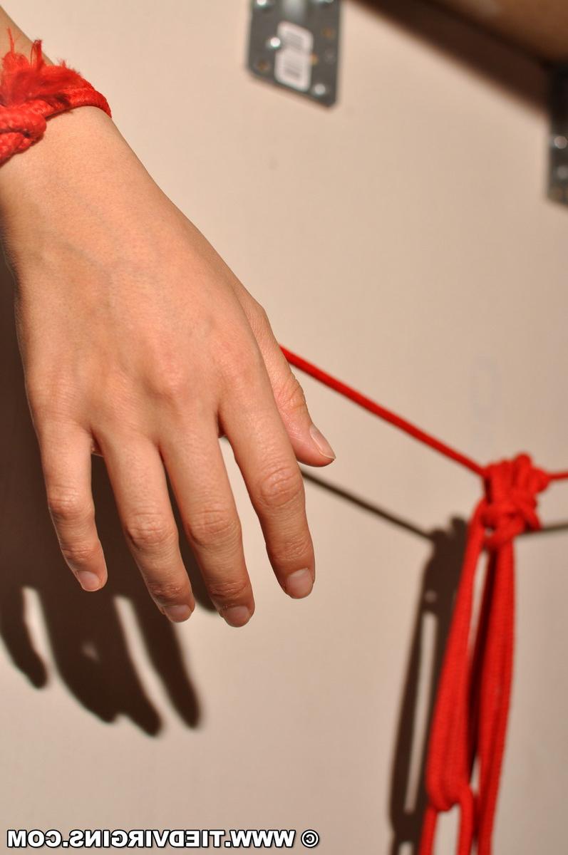 12P Dark-haired girl is affixed to a table in the nude while ball gagged