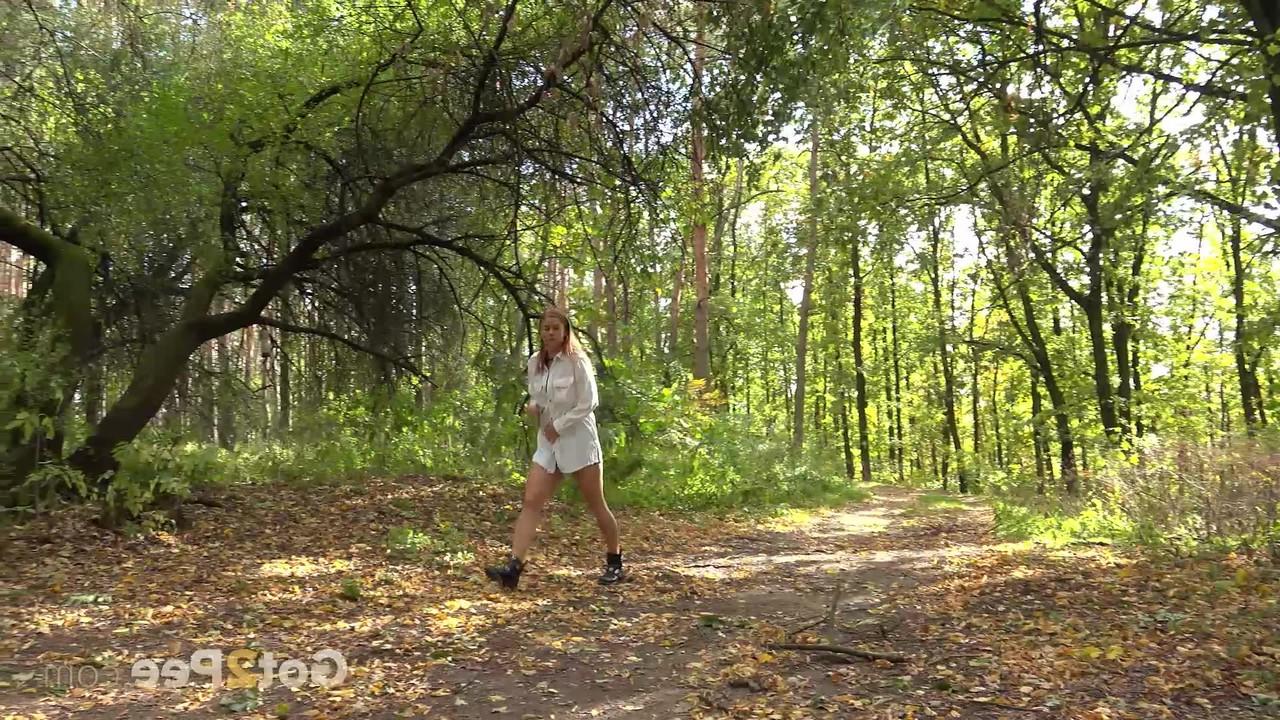 15P Caucasian girl Chrissy Fox takes a piss while sitting on a bench in the woods