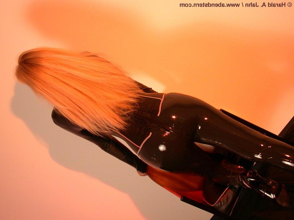 16P Natural blonde finds herself restrained to a glass table in latex clothing