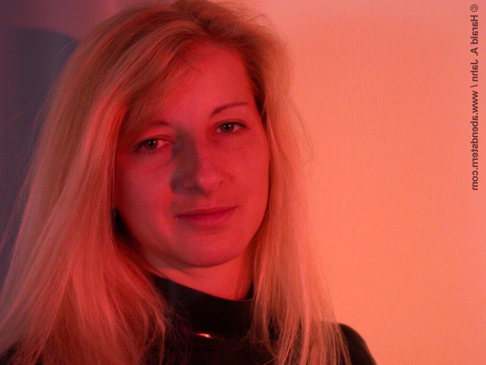 16P Natural blonde finds herself restrained to a glass table in latex clothing