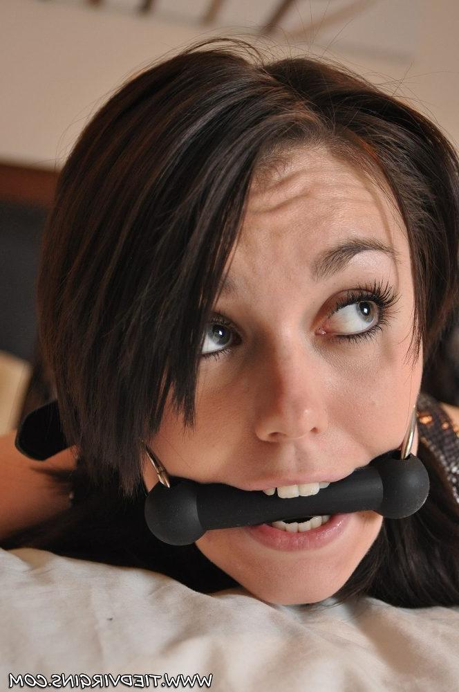 12P British girl Kacie James bites down on a horse bit while restrained on a bed