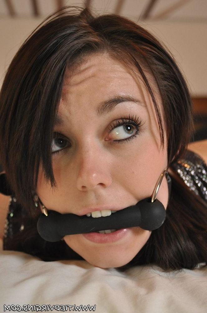 12P British girl Kacie James bites down on a horse bit while restrained on a bed