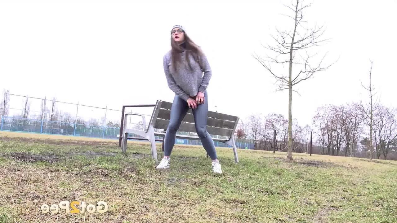 15P Caucasian girl Barbara Bieber pulls down her leggings to piss in a field