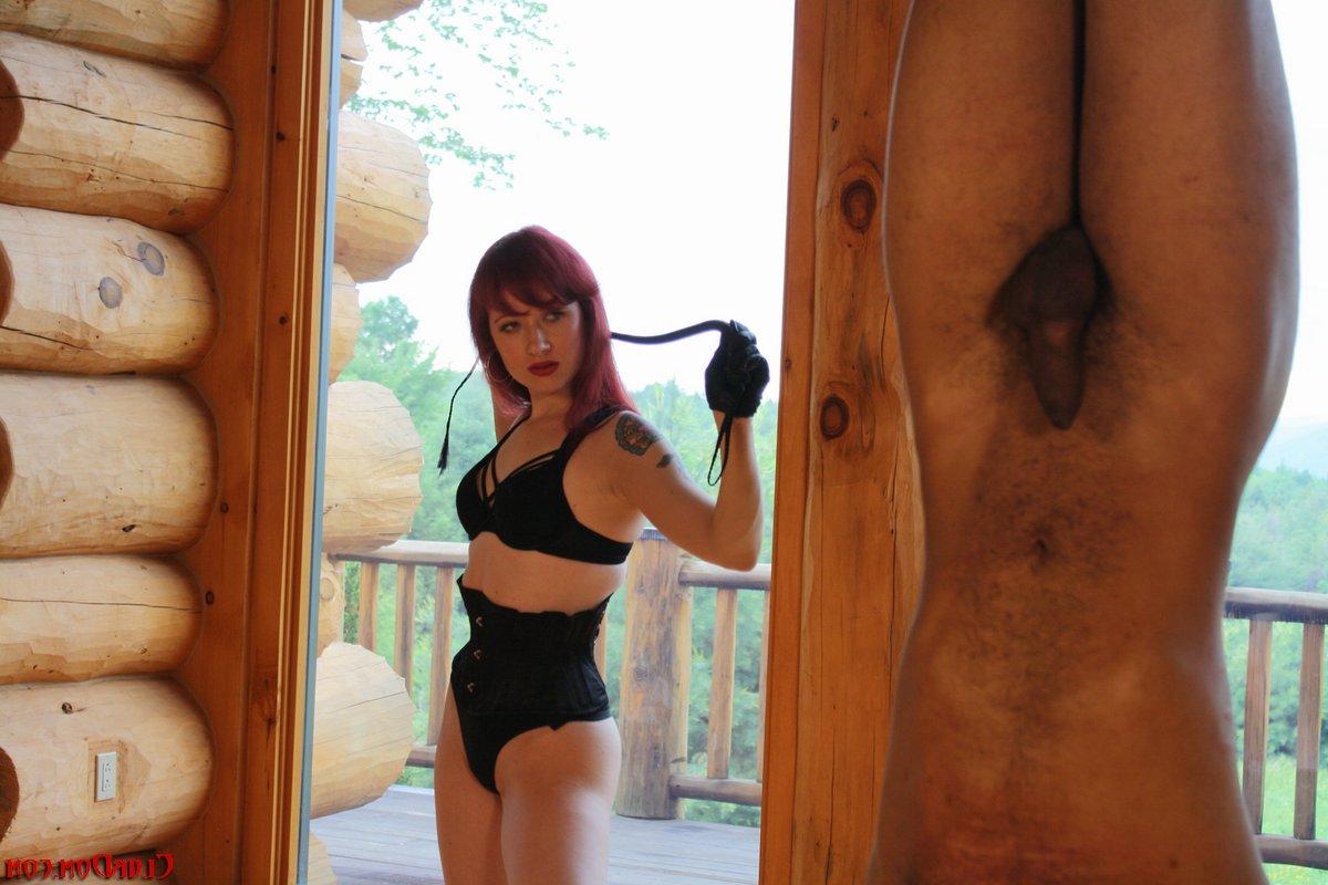 9P Redhead domme Mistress Varla whips a slave who's hanging from the ceiling