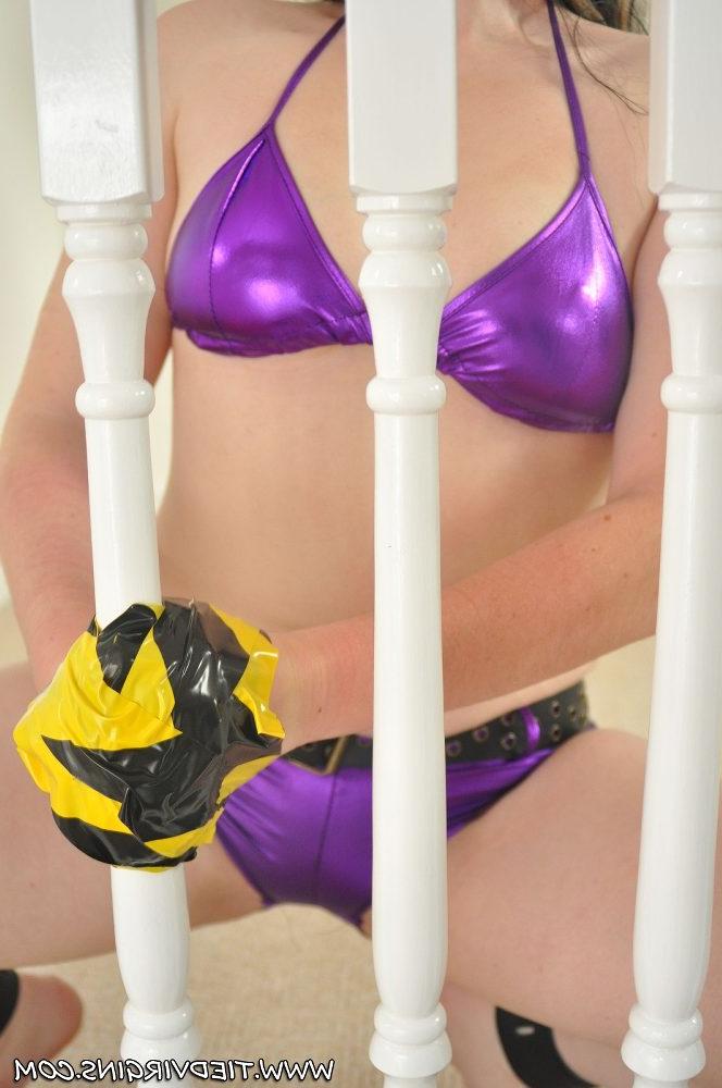 12P Dirty blonde is affixed to a railing while wearing a purple bikini