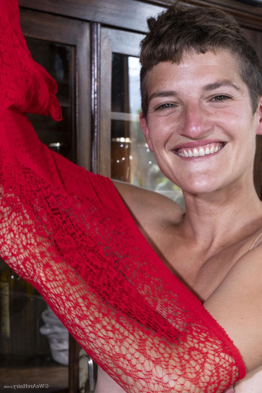 20P Short haired babe Gloria M removes her sheer lacy dress & rubs her bushy cunt