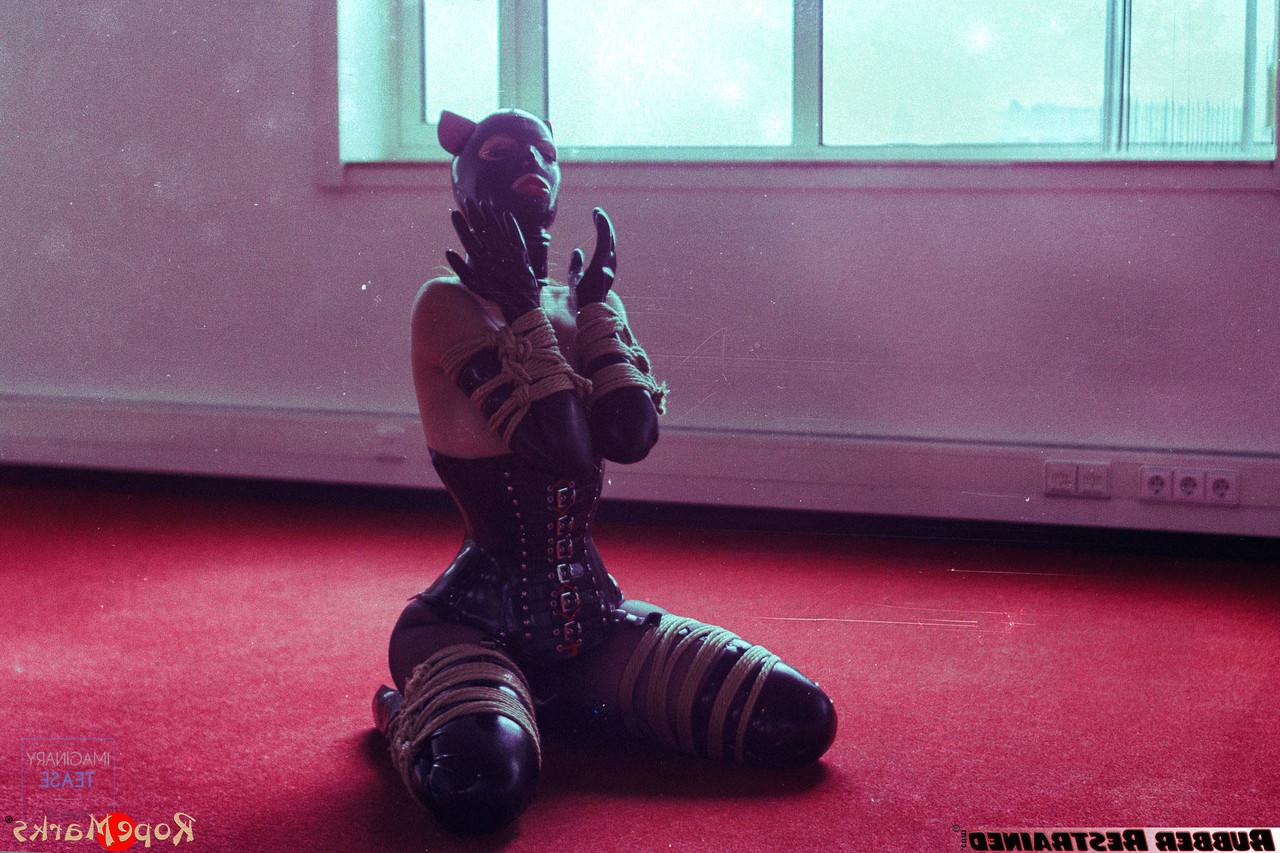 16P Redheaded girl Amarantha Lablanche is restrained with ropes in a latex outfit