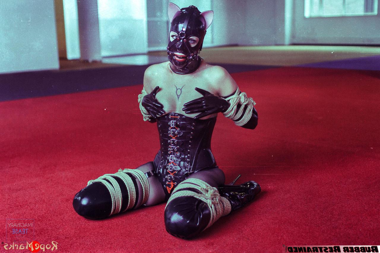 16P Redheaded girl Amarantha Lablanche is restrained with ropes in a latex outfit
