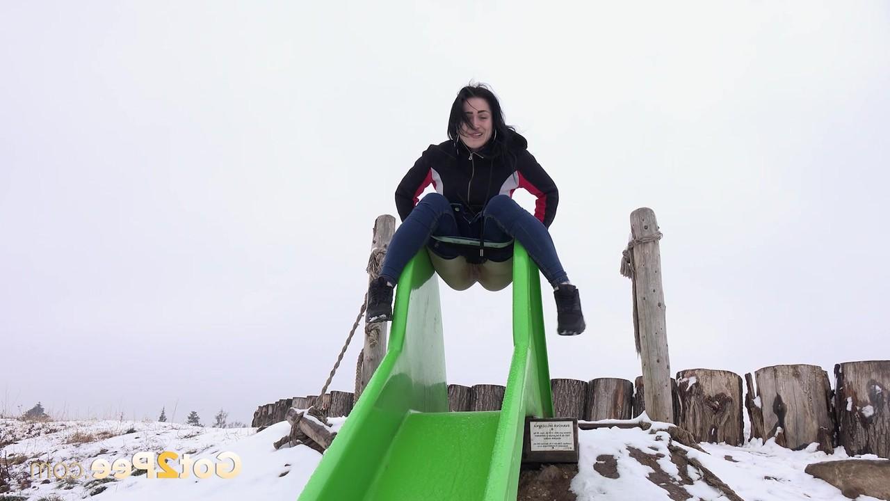15P Dark-haired girl Selena takes a piss on a slide during the winter