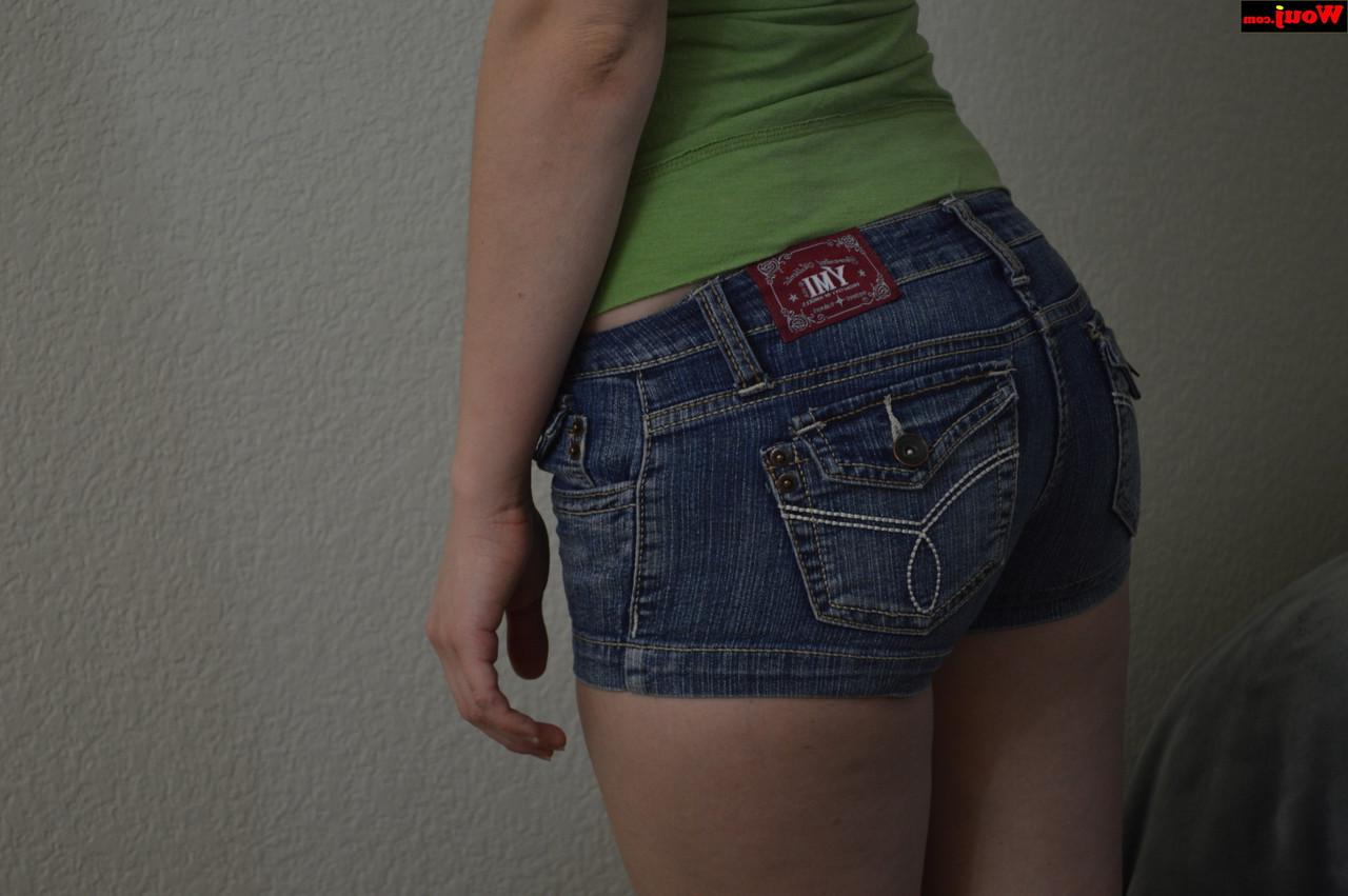 15P Linda adolescente amadora posando com uma camisa verde e shorts jeans sexy