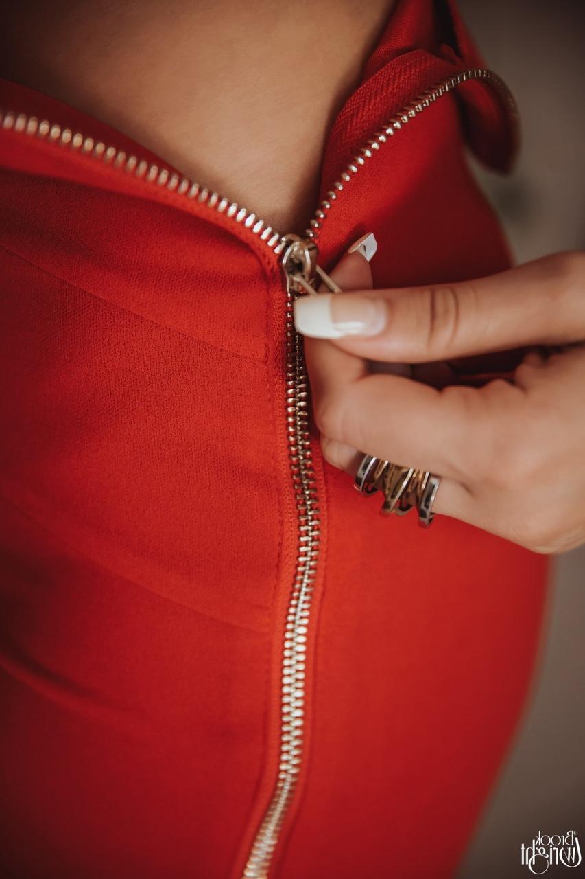 12P Hot brunette Brook Wright unzips a red skirt to pose nude afore a mirror