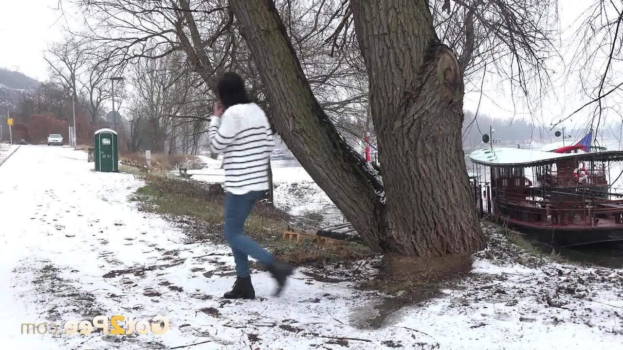 15P Brunette chick Esperansa pees against a tree upon snow-covered ground
