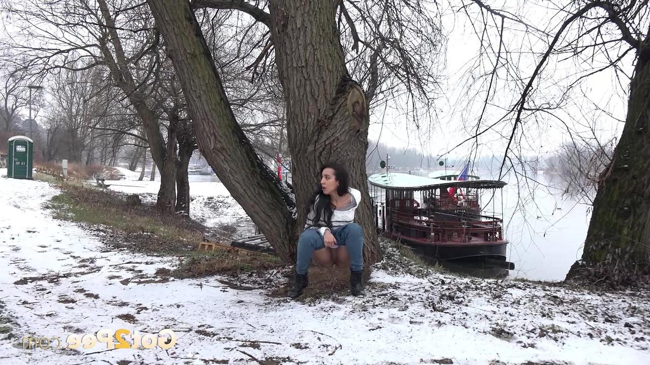 15P Brunette chick Esperansa pees against a tree upon snow-covered ground