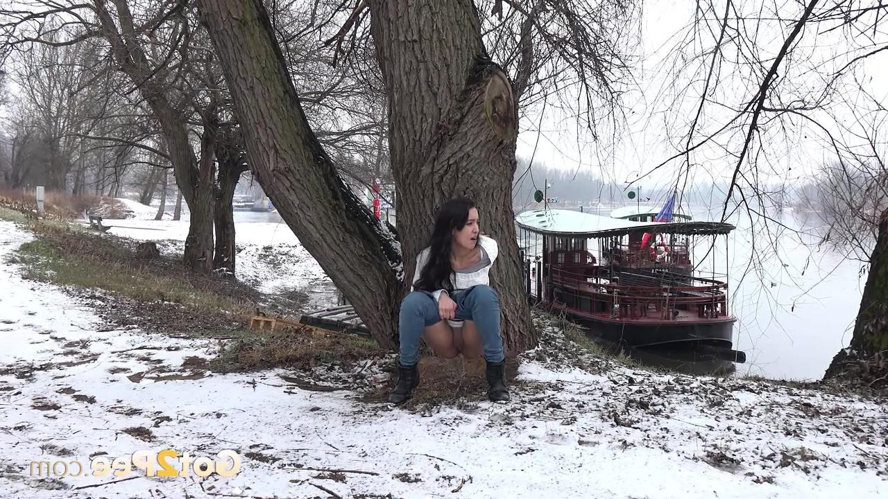 15P Brunette chick Esperansa pees against a tree upon snow-covered ground