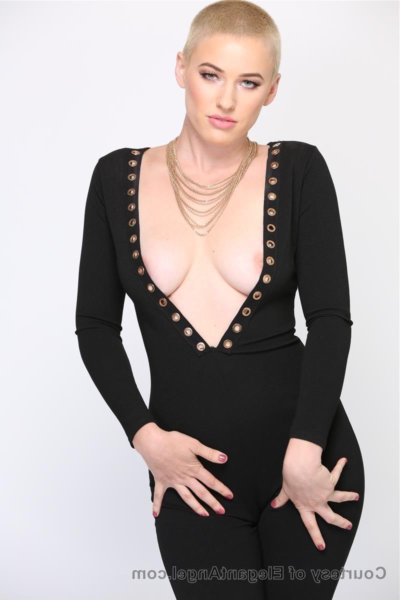 20P Blonde Riley Nixon poses in her tight black outfit & unveils her big tits