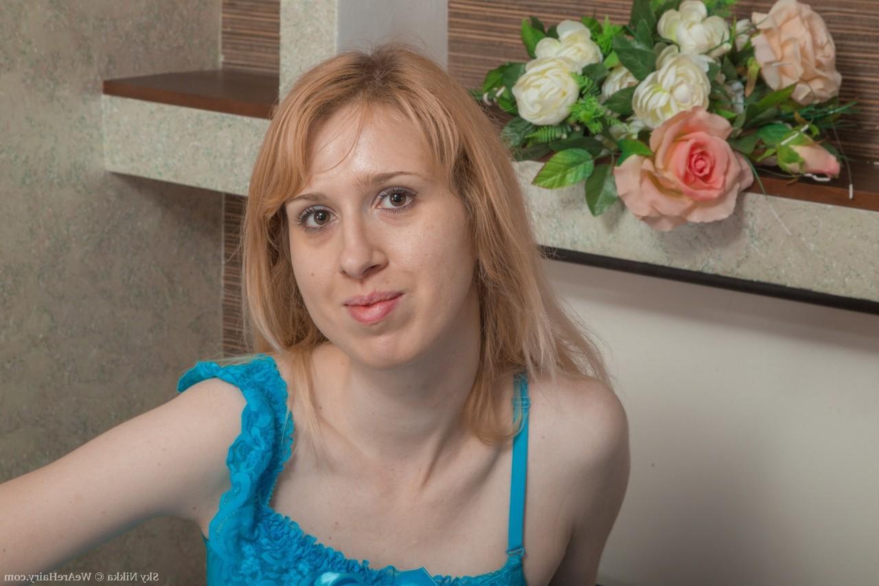 16P Pale redhead Sky Nikka shows off the pink of her bush while posing nude