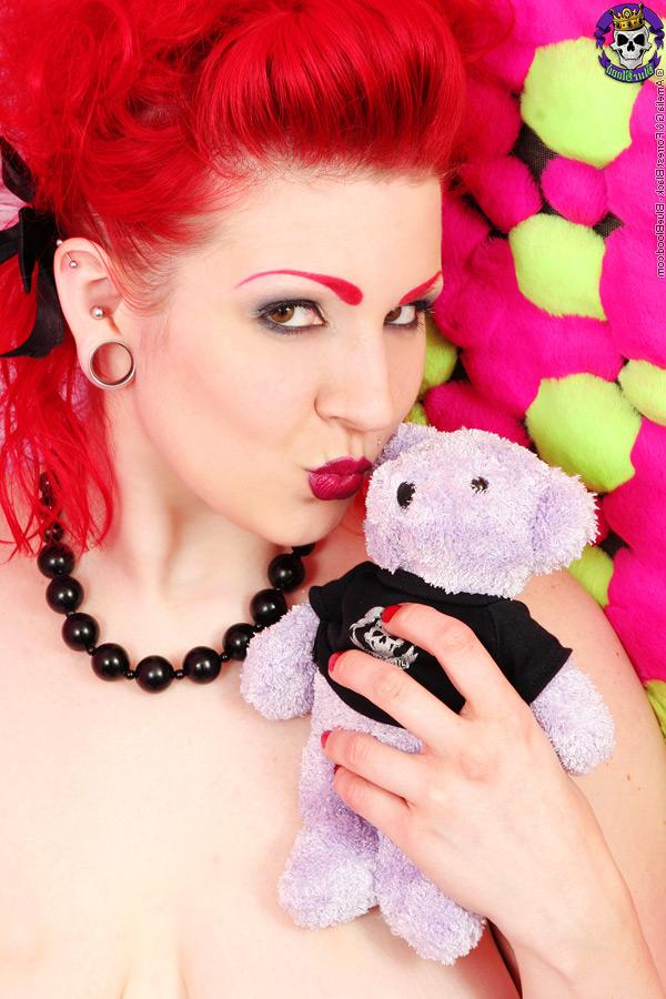 15P Flaming redhead Xanthia Doll displays her big natural tits during a solo show