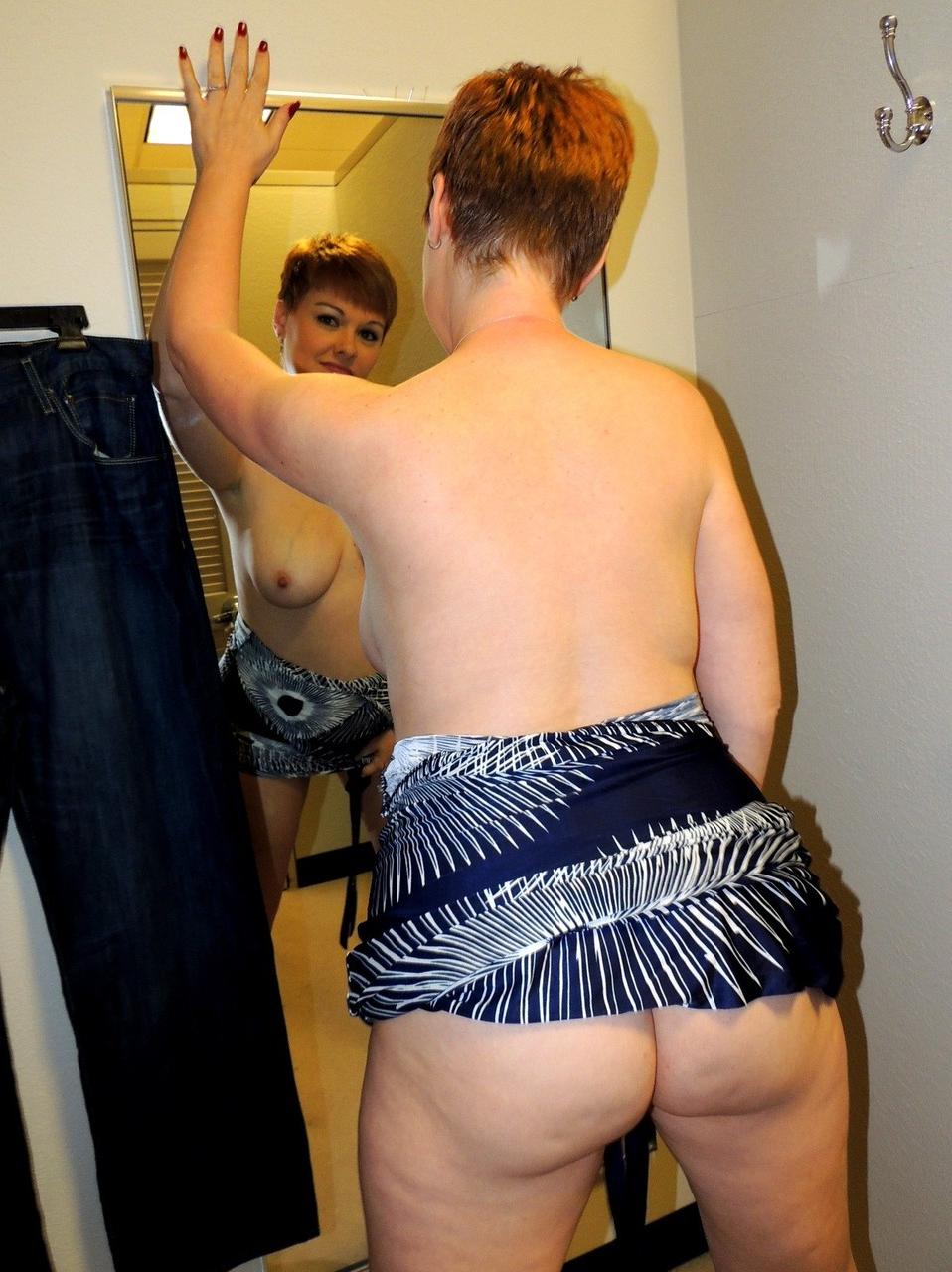 17P Sexy MILF with short red hair gives a blowjob in a dressing room at the mall